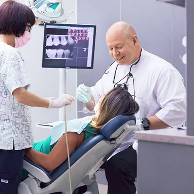 Dentist and hygienist working on patient